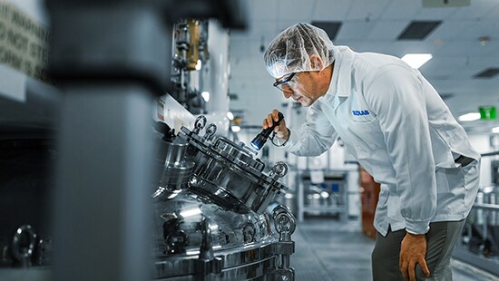 Detail of an illustration of a manufacturing plant with the numbers 1 and 2 pointed out.